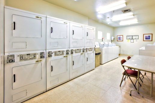 Laundry Room with at least 8 washers and 8 dryers, table and chairs