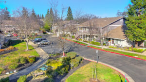 Exterior Aerial of Wood creek terrace residential buildings landscaping, and outdoor bench area.